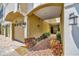 Covered walkway leads to the front door with brick pavers, garden bed, and exterior lighting at 4062 Overture Cir # 4062, Bradenton, FL 34209