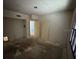 Empty room with two doors, a window, and flooring waiting to be replaced at 7321 Central Ave # 504, St Petersburg, FL 33710