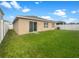 Spacious backyard with a well-maintained lawn and a white fence, perfect for outdoor activities and relaxation at 11510 Southern Creek Dr, Gibsonton, FL 33534