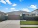 Charming single-story home with a well-manicured front yard and a spacious two-car garage, perfect for suburban living at 11510 Southern Creek Dr, Gibsonton, FL 33534