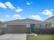Charming single-story home with a well-manicured front yard and a spacious two-car garage, perfect for suburban living at 11510 Southern Creek Dr, Gibsonton, FL 33534