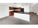 Modern kitchen with dark cabinetry, black appliances, and a large island with countertop seating at 11510 Southern Creek Dr, Gibsonton, FL 33534