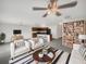Open-concept living room featuring modern decor, a ceiling fan, and seamless flow to a kitchen with a breakfast bar at 11510 Southern Creek Dr, Gibsonton, FL 33534