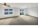 Bright living room featuring neutral carpet, ceiling fan, sliding glass door and a window at 11510 Southern Creek Dr, Gibsonton, FL 33534