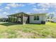 Spacious backyard with a screened-in patio area, perfect for outdoor relaxation and entertaining at 12387 Eastpointe Dr, Dade City, FL 33525