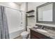 Bathroom featuring a shower, toilet, floating shelves, decorative mirror, and granite countertop vanity at 12387 Eastpointe Dr, Dade City, FL 33525