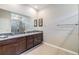 Spacious bathroom with double vanities, granite countertops, and a glass-enclosed shower at 12387 Eastpointe Dr, Dade City, FL 33525