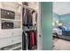 Organized walk-in closet adjacent to bedroom with plenty of hanging storage with shelves and drawers at 12387 Eastpointe Dr, Dade City, FL 33525