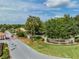 Welcoming entrance to Lake Jovita with lush landscaping and a secure gate, providing a sense of community at 12387 Eastpointe Dr, Dade City, FL 33525