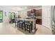 Stylish kitchen with island seating, stainless steel appliances, and a dining area with plenty of natural light at 12387 Eastpointe Dr, Dade City, FL 33525