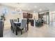 Open-concept kitchen and dining area with granite countertops, stainless appliances, and an island with seating at 12387 Eastpointe Dr, Dade City, FL 33525
