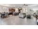 Open-concept living space with kitchen island, dining area, and tile floors, perfect for entertaining at 12387 Eastpointe Dr, Dade City, FL 33525