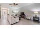 Comfortable living room with tile flooring, modern ceiling fan, and cozy furniture arrangement at 12387 Eastpointe Dr, Dade City, FL 33525
