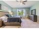 Tranquil main bedroom featuring a ceiling fan, soft lighting, and large windows with a view at 12387 Eastpointe Dr, Dade City, FL 33525
