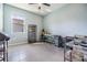 Bright office or craft room with multiple tables, shelves and a large window providing plenty of light at 12387 Eastpointe Dr, Dade City, FL 33525