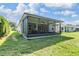 Screened outdoor patio with a fan and string lights for outdoor dining and relaxing at 12387 Eastpointe Dr, Dade City, FL 33525
