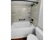 Modern bathroom features a bathtub with tile surround, matte black fixtures, and built-in shelves at 1857 Clearbrooke Dr, Clearwater, FL 33760