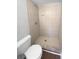 Tiled shower with silver hardware in renovated bathroom at 1857 Clearbrooke Dr, Clearwater, FL 33760