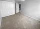 Bedroom with carpet, a ceiling fan, double closets, an open doorway, and neutral paint at 1857 Clearbrooke Dr, Clearwater, FL 33760