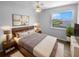 Cozy bedroom featuring a comfortable bed, ample natural light, and a serene view of the sports field at 1857 Clearbrooke Dr, Clearwater, FL 33760