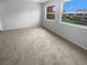 Large bedroom featuring plush carpet, two windows providing natural light, and neutral decor at 1857 Clearbrooke Dr, Clearwater, FL 33760