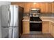 Well-appointed kitchen featuring stainless steel appliances, wood cabinetry, and modern finishes at 1857 Clearbrooke Dr, Clearwater, FL 33760