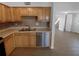 Well-appointed kitchen featuring stainless steel appliances, wood cabinetry, and modern sink at 1857 Clearbrooke Dr, Clearwater, FL 33760