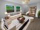 Bright living room with large windows, modern furniture and open floor plan, perfect for relaxation and entertainment at 1857 Clearbrooke Dr, Clearwater, FL 33760