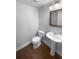 Powder room with wood flooring, toilet and pedestal sink at 1857 Clearbrooke Dr, Clearwater, FL 33760