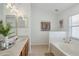 Bright bathroom featuring double vanity with a tub and shower at 13405 Fawn Springs Dr, Tampa, FL 33626