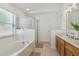 Bright bathroom featuring double vanity with a tub and shower at 13405 Fawn Springs Dr, Tampa, FL 33626