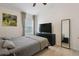 Bedroom featuring a queen bed, a large dresser and a full length mirror at 13405 Fawn Springs Dr, Tampa, FL 33626