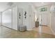 Spacious foyer with tile flooring, storage, modern decor, and a window to the exterior at 13405 Fawn Springs Dr, Tampa, FL 33626