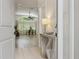 Bright and inviting foyer with neutral tile flooring, view of the dining room, and modern decor at 13405 Fawn Springs Dr, Tampa, FL 33626
