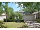Charming single-Gathering home featuring lush landscaping and a cozy front porch bench at 13405 Fawn Springs Dr, Tampa, FL 33626