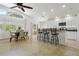 Bright kitchen with granite countertops, barstool seating, white cabinets, and stainless steel appliances at 13405 Fawn Springs Dr, Tampa, FL 33626