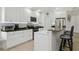 Modern kitchen features granite countertops, white cabinets, breakfast bar, and stainless steel appliances at 13405 Fawn Springs Dr, Tampa, FL 33626