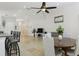 Spacious living room featuring tile floors, open layout, a ceiling fan, breakfast bar, and natural light at 13405 Fawn Springs Dr, Tampa, FL 33626