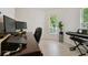 Well-lit office with a computer, plant, desk, and keyboard at 13405 Fawn Springs Dr, Tampa, FL 33626