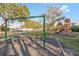 Community playground with swings, climbing structures, and a slide, perfect for Gathering fun at 13405 Fawn Springs Dr, Tampa, FL 33626