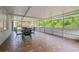 Spacious sunroom featuring tile floors, a ceiling fan, and a screened-in patio at 13405 Fawn Springs Dr, Tampa, FL 33626