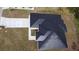 Birds eye view of new home with a dark roof, white exterior and fresh landscaping in a residential neighborhood at 2551 Alhaven Ter, North Port, FL 34286