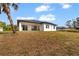Exterior of home with a manicured lawn and a covered patio, perfect for outdoor living at 2551 Alhaven Ter, North Port, FL 34286
