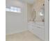 Modern bathroom features double sink vanity, decorative wall and marble floors at 2551 Alhaven Ter, North Port, FL 34286