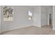 Bright, airy bedroom featuring hardwood floors, large windows, and a view of the neighborhood at 2551 Alhaven Ter, North Port, FL 34286