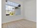 Bright bedroom with a large window providing neighborhood views and hardwood floors at 2551 Alhaven Ter, North Port, FL 34286