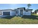 Charming single-story home features a black garage door, tiled roof, and well-maintained lawn at 2551 Alhaven Ter, North Port, FL 34286