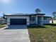 Charming single-Gathering home featuring a well-maintained lawn, a driveway, and a two-car garage at 2551 Alhaven Ter, North Port, FL 34286