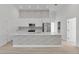 Stylish kitchen with modern backsplash, stainless appliances, and a large kitchen island at 2551 Alhaven Ter, North Port, FL 34286