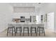 Bright, modern kitchen with stainless steel appliances, a large island, bar seating, and decorative backsplash at 2551 Alhaven Ter, North Port, FL 34286